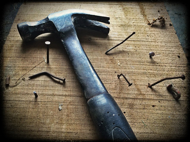 Hammer and nails in a board