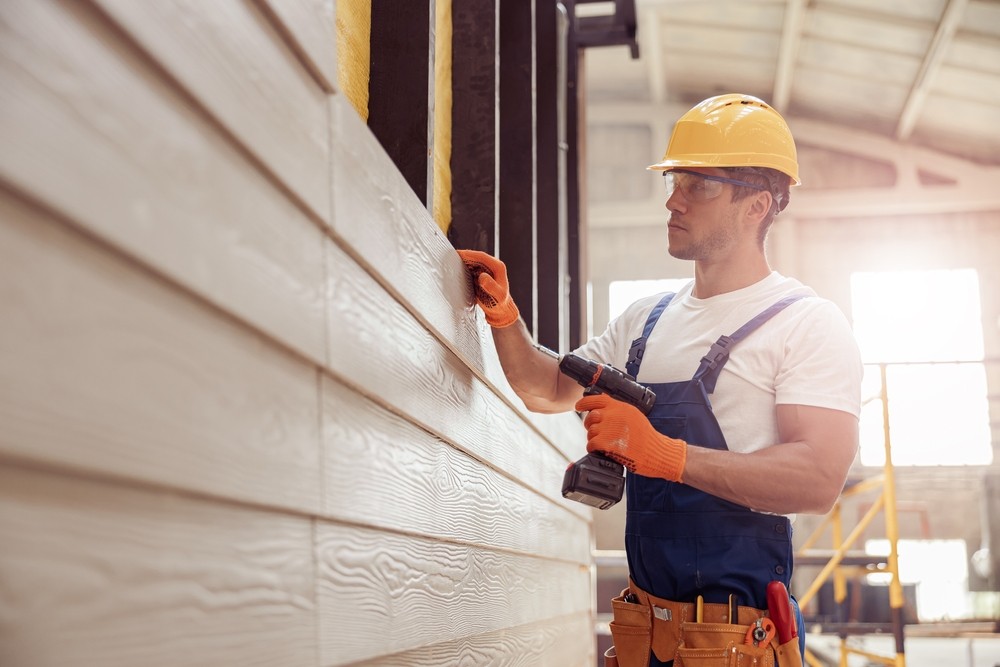 Contruction Worker Putting Up Siding